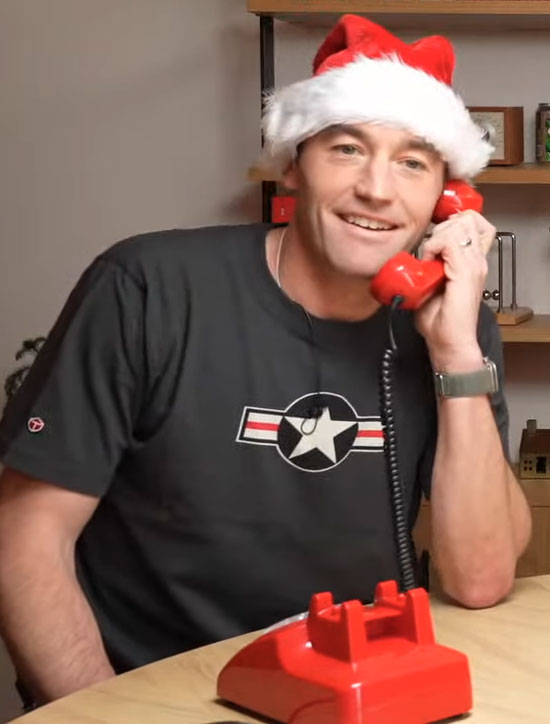 Image of a man speaking with ChatGPT with an old fashioned rotary phone